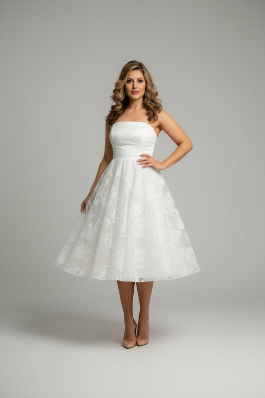 Woman trying on a white dress in front of a mirror.