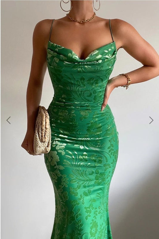 Green lace dress worn by a person on a plain background