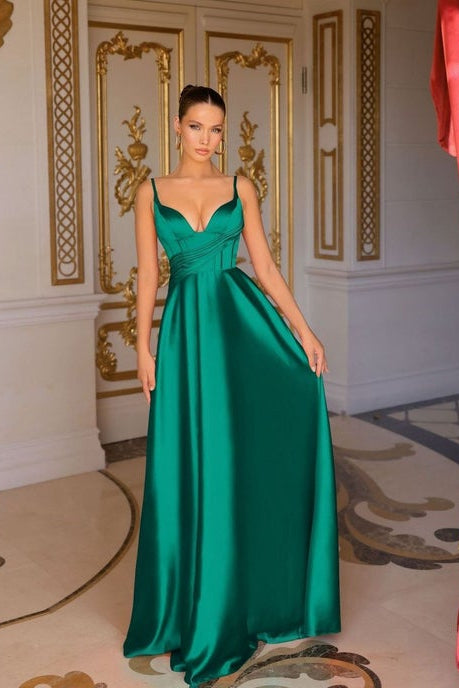 Woman wearing a green evening gown in an ornate room.