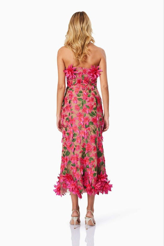 Woman wearing a pink floral dress on a white background