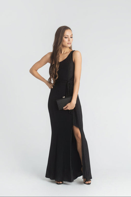 Woman wearing a black one-shoulder dress with a slit on a white background