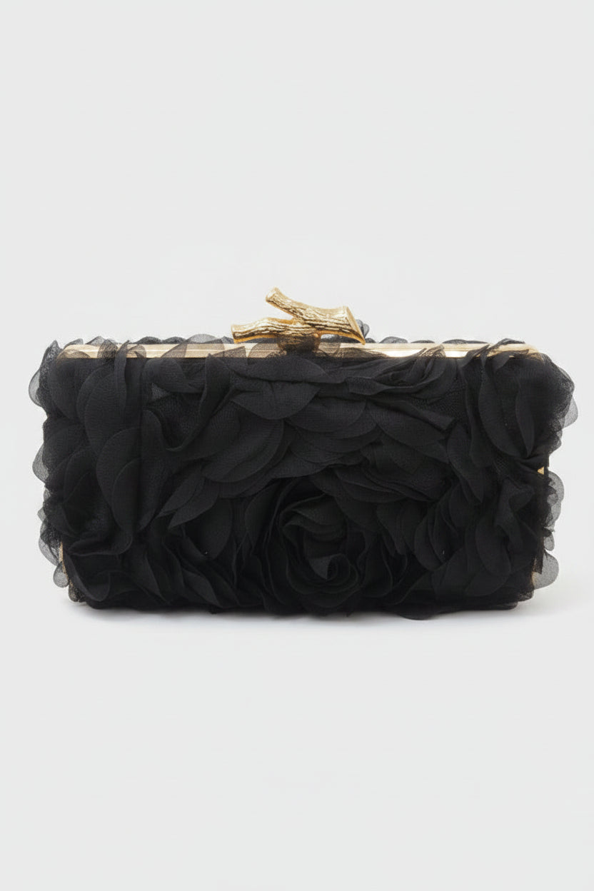 Black clutch with gold accents on a white background