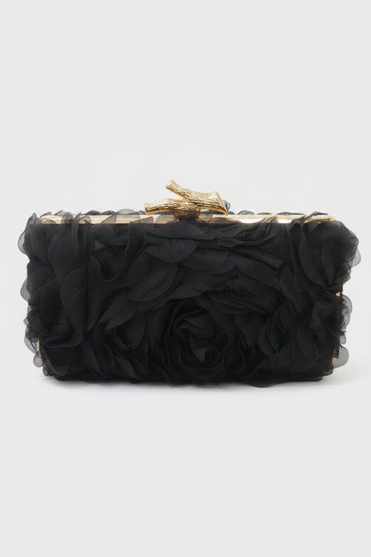Black clutch with gold accents on a white background