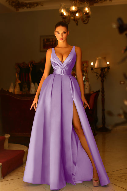 Woman in a purple evening gown with a high slit.