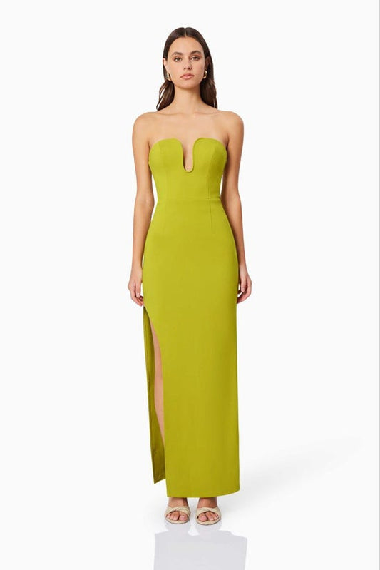 Woman wearing a strapless green gown with a slit on a white background