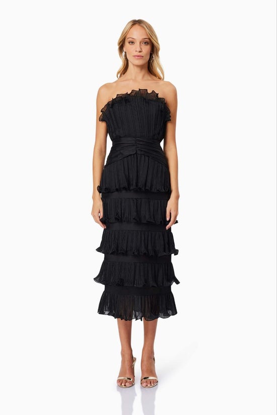 Black strapless ruffled dress worn by a model on a white background