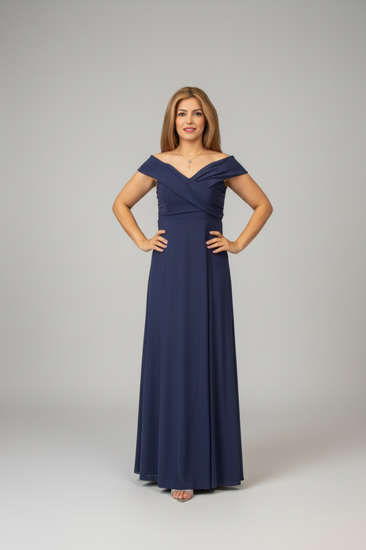 Woman in a long navy dress standing in front of a mirror in an elegant room.