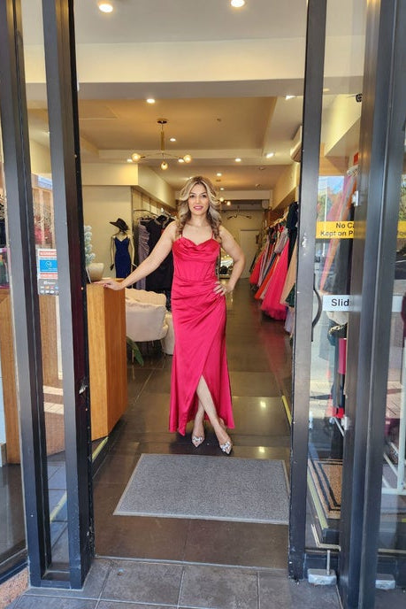Woman in a pink dress standing in a clothing store