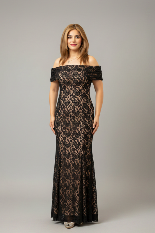 A woman modeling an off-the-shoulder black lace maxi dress against a solid gray studio background.