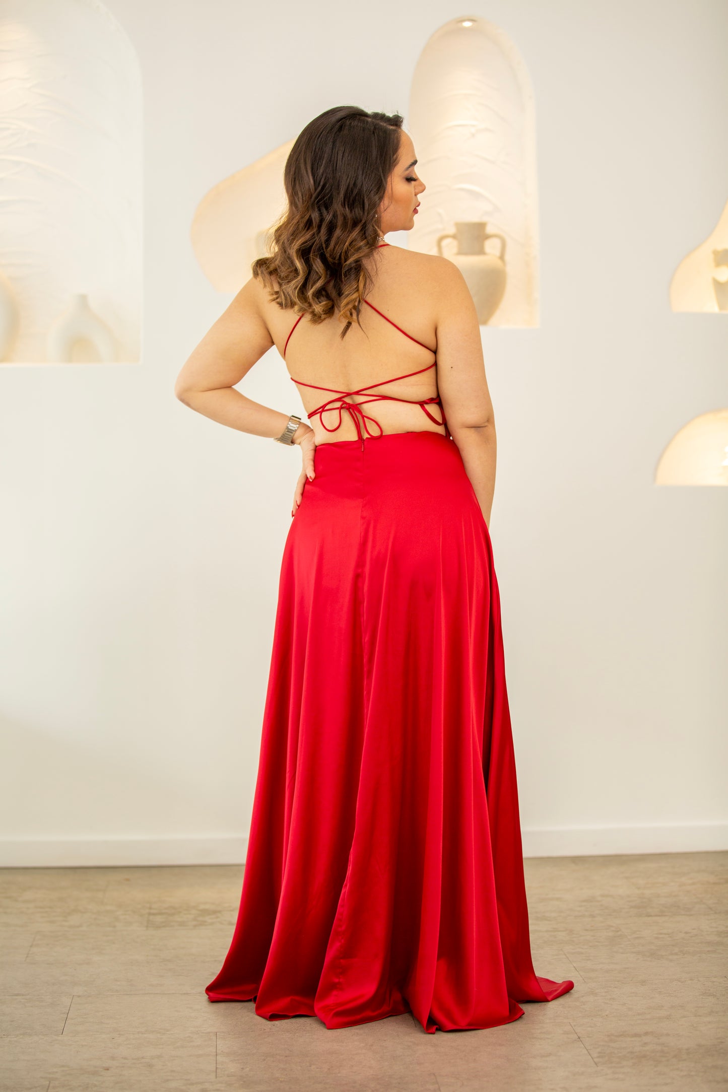 Woman wearing a red evening gown with a white background
