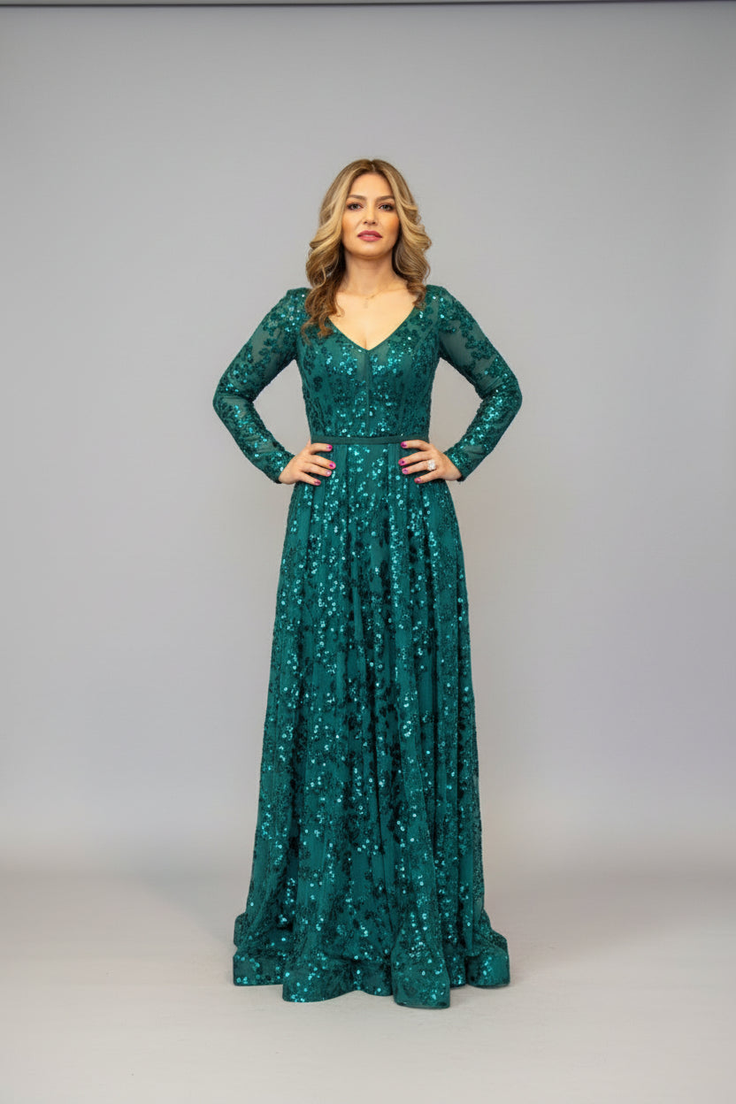 Woman in a green sequin dress standing in room.