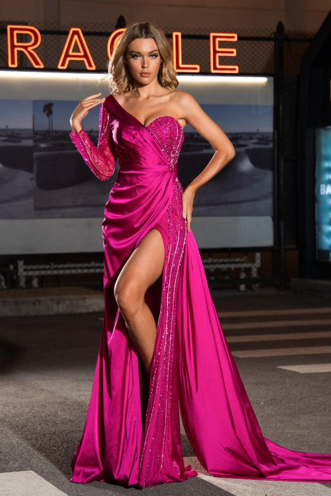Woman in a pink evening gown standing on a street with neon signs in the background