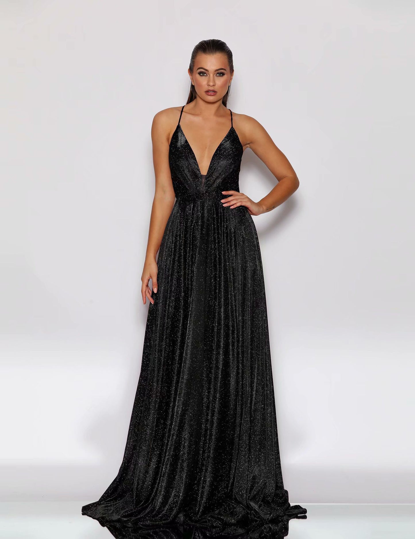 Woman wearing a black evening gown against a white background