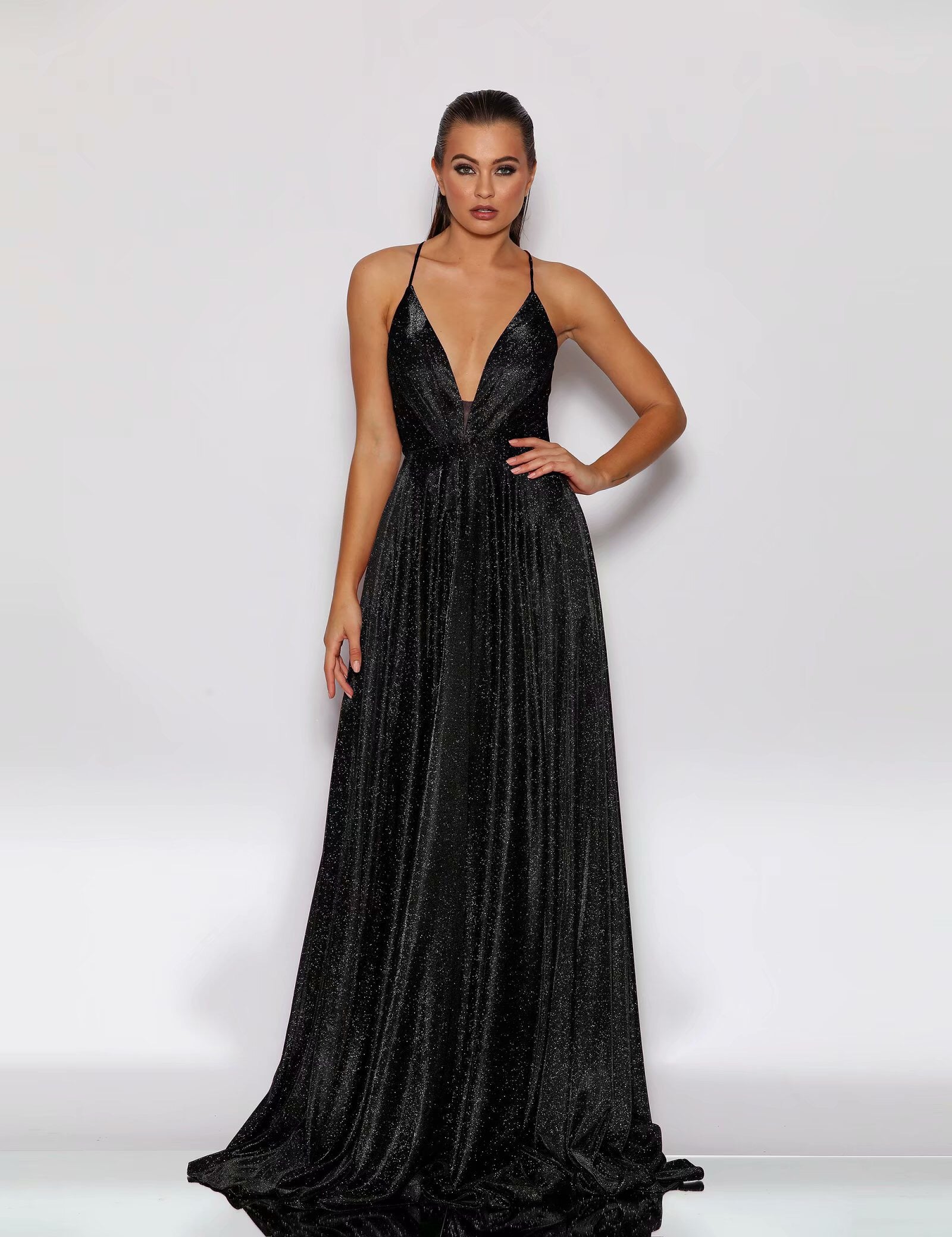 Woman wearing a black evening gown against a white background