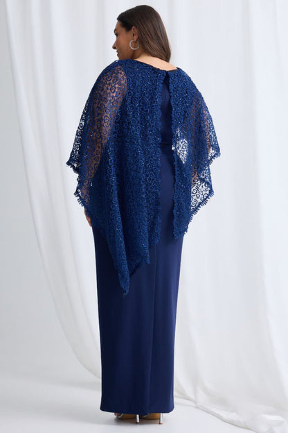 Woman wearing a navy blue lace shawl over a matching dress against a white background
