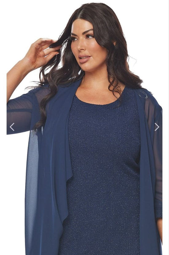 Woman wearing a blue dress with a matching cardigan on a white background