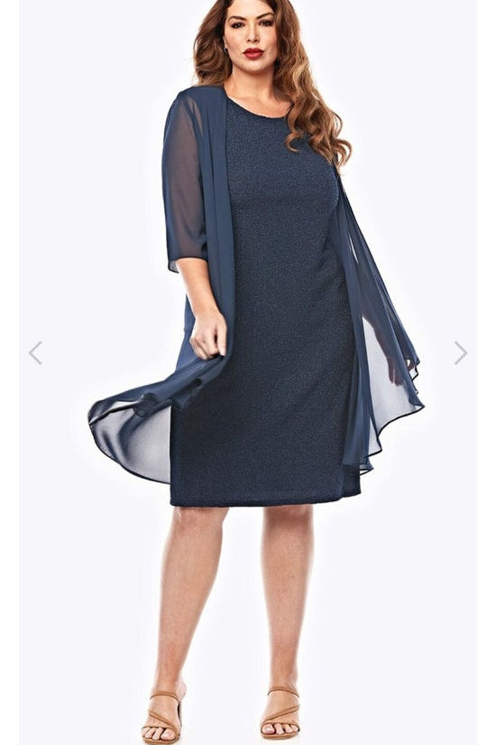 Woman wearing a navy dress with a matching jacket on a white background
