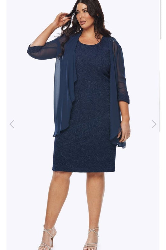 Woman wearing a navy dress with a matching jacket on a white background