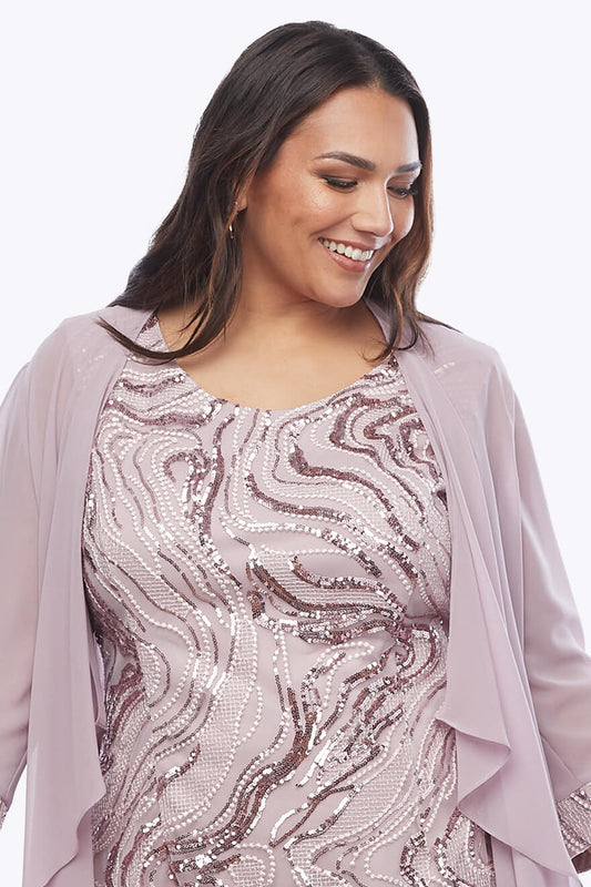 Woman wearing a sequined dress with a matching jacket on a white background