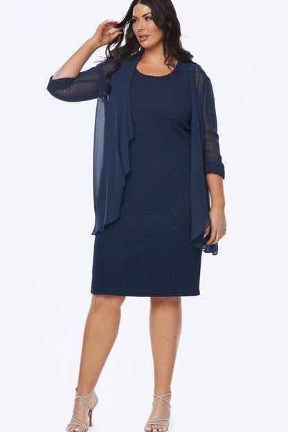 Woman wearing a navy dress with a matching jacket on a white background