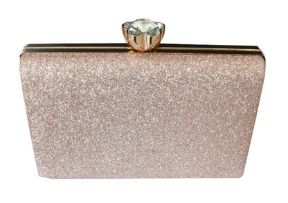 Sparkly clutch purse with a gemstone clasp on a white background