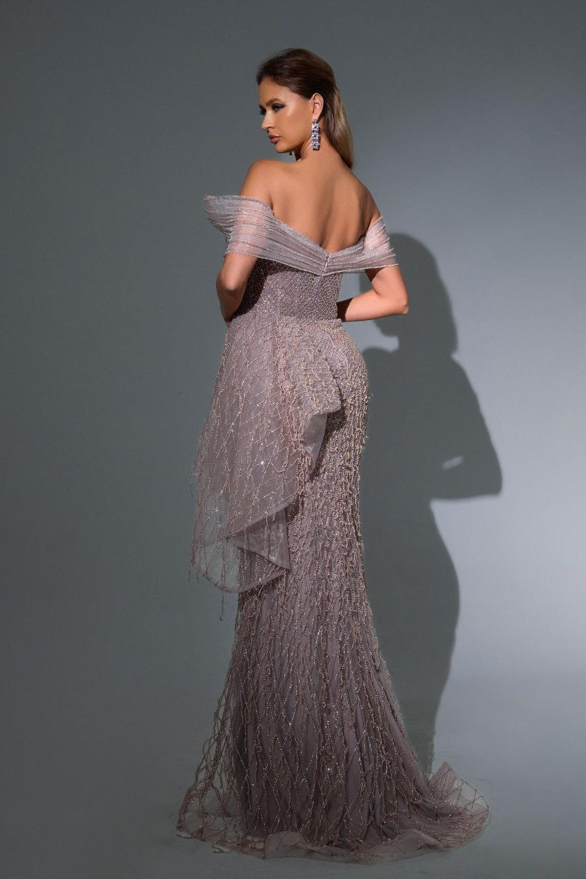Woman wearing a sparkling evening gown against a gray background