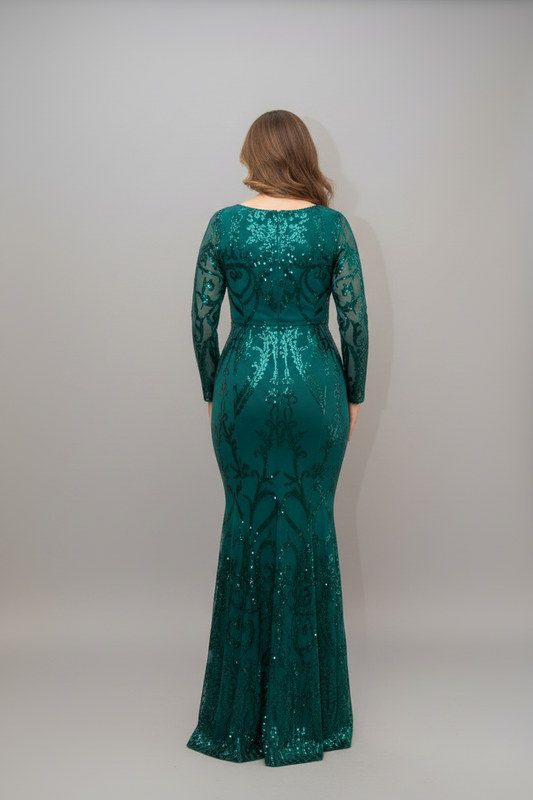 Woman in a teal sequin dress standing in front of a mirror.