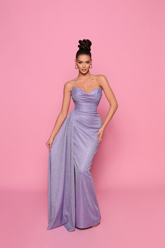 Woman wearing a strapless purple gown on a pink background