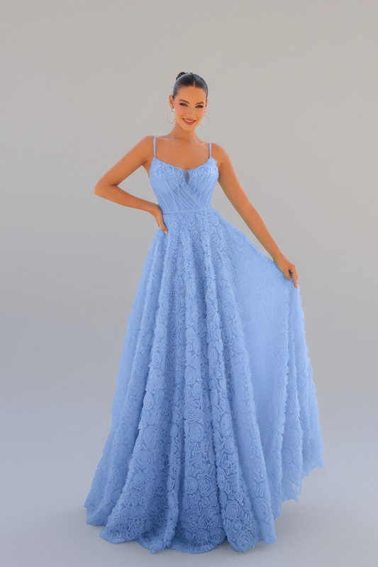 A woman modeling a light blue lace ball gown with spaghetti straps and a full skirt, standing against a solid light gray studio background.