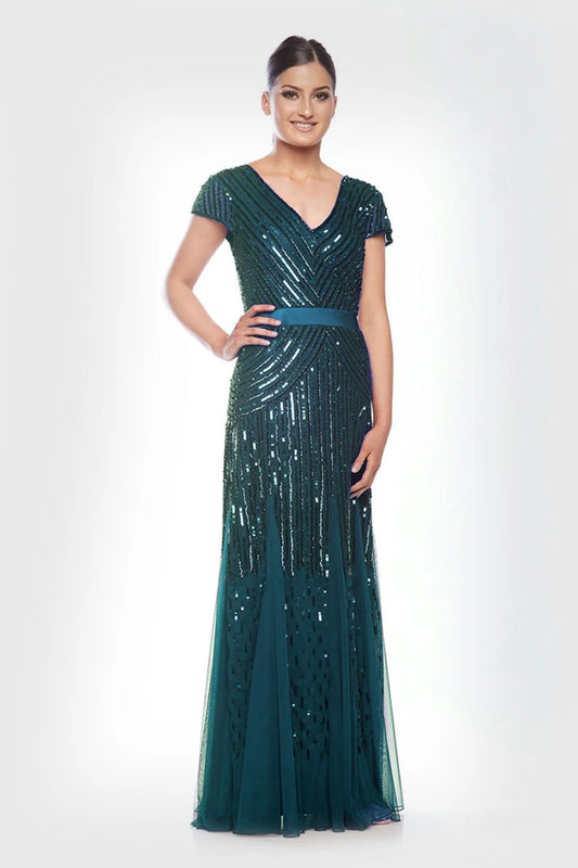 Woman wearing a green sequined evening gown on a white background