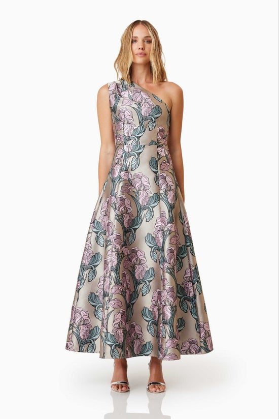 Woman wearing a floral one-shoulder dress on a white background