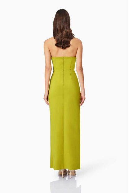Woman wearing a strapless green dress on a white background