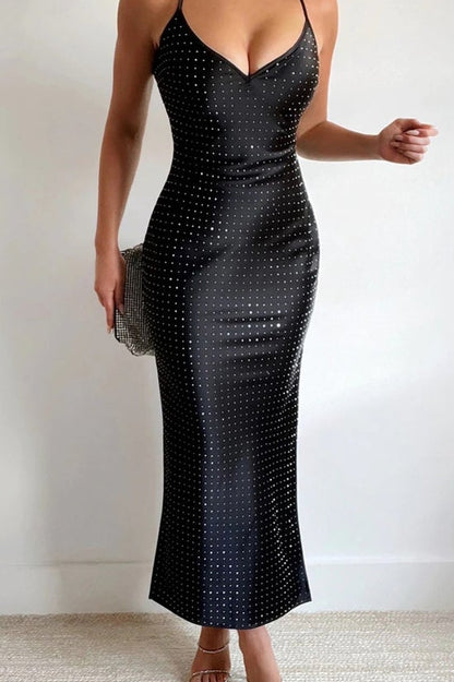 Black sequin dress worn by a person on a plain background